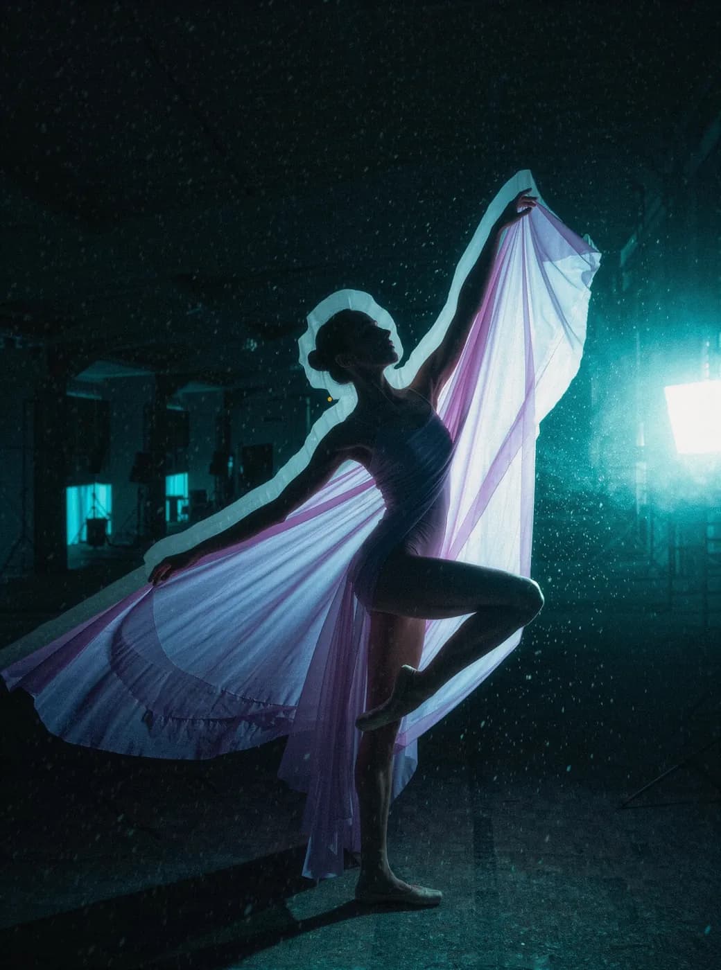 A dancer trailing silk under studio light